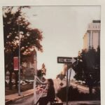 Gallery 2 - A solo female harpist plays underneath a street sign that says \\\